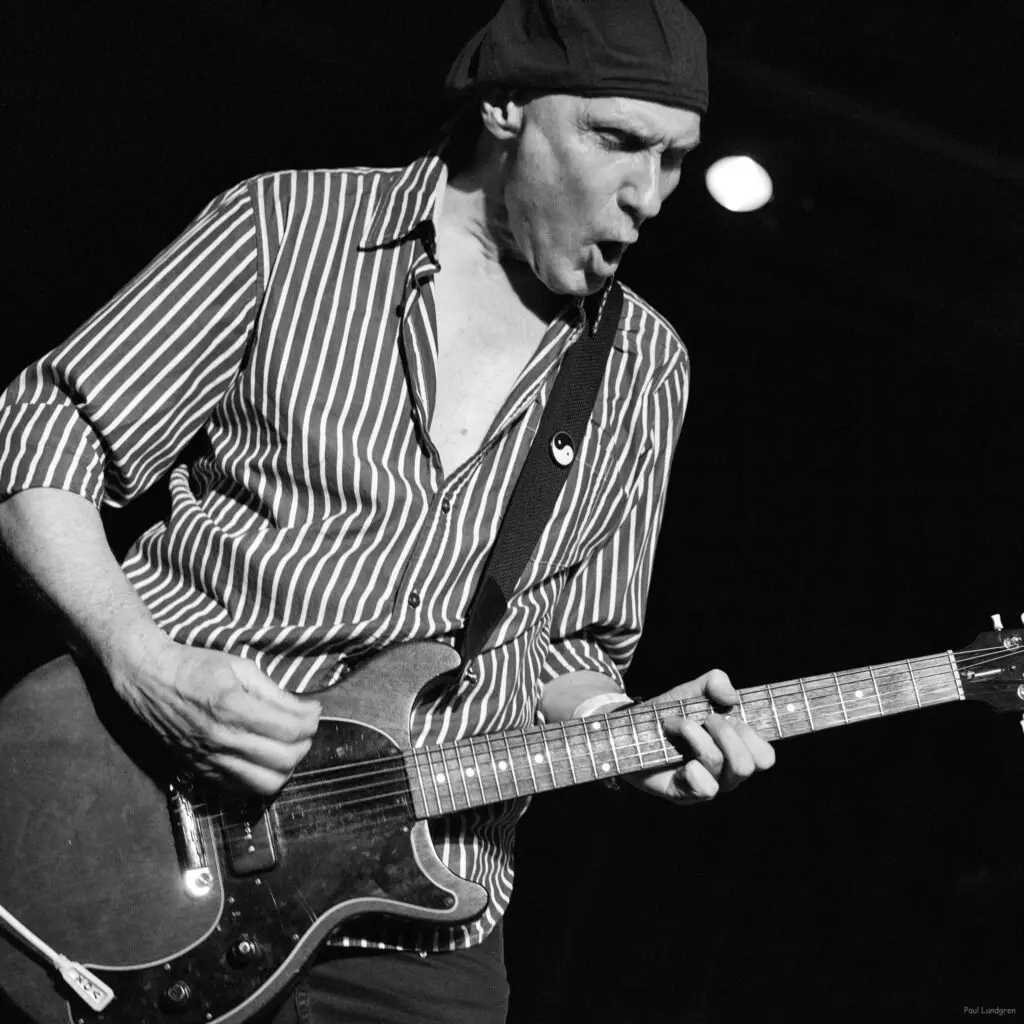 Terry Isachsen playing guitar on stage at the VFW Uptown.