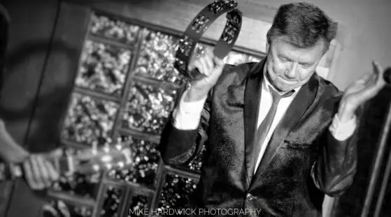 Mark Engebretson shaking a tambourine.