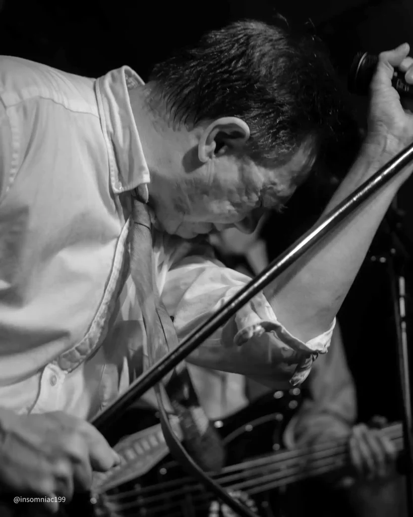 Mark holding on to the mic stand at the White Squirrel.