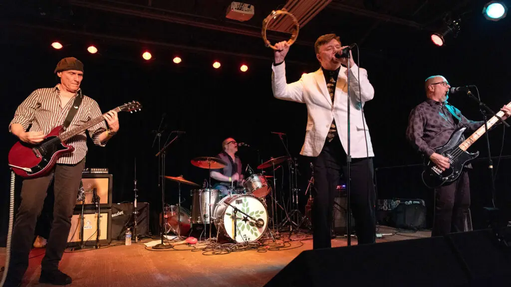 The Silverteens at the VFW Uptown in color. Mark is holding a tambourine above his head.